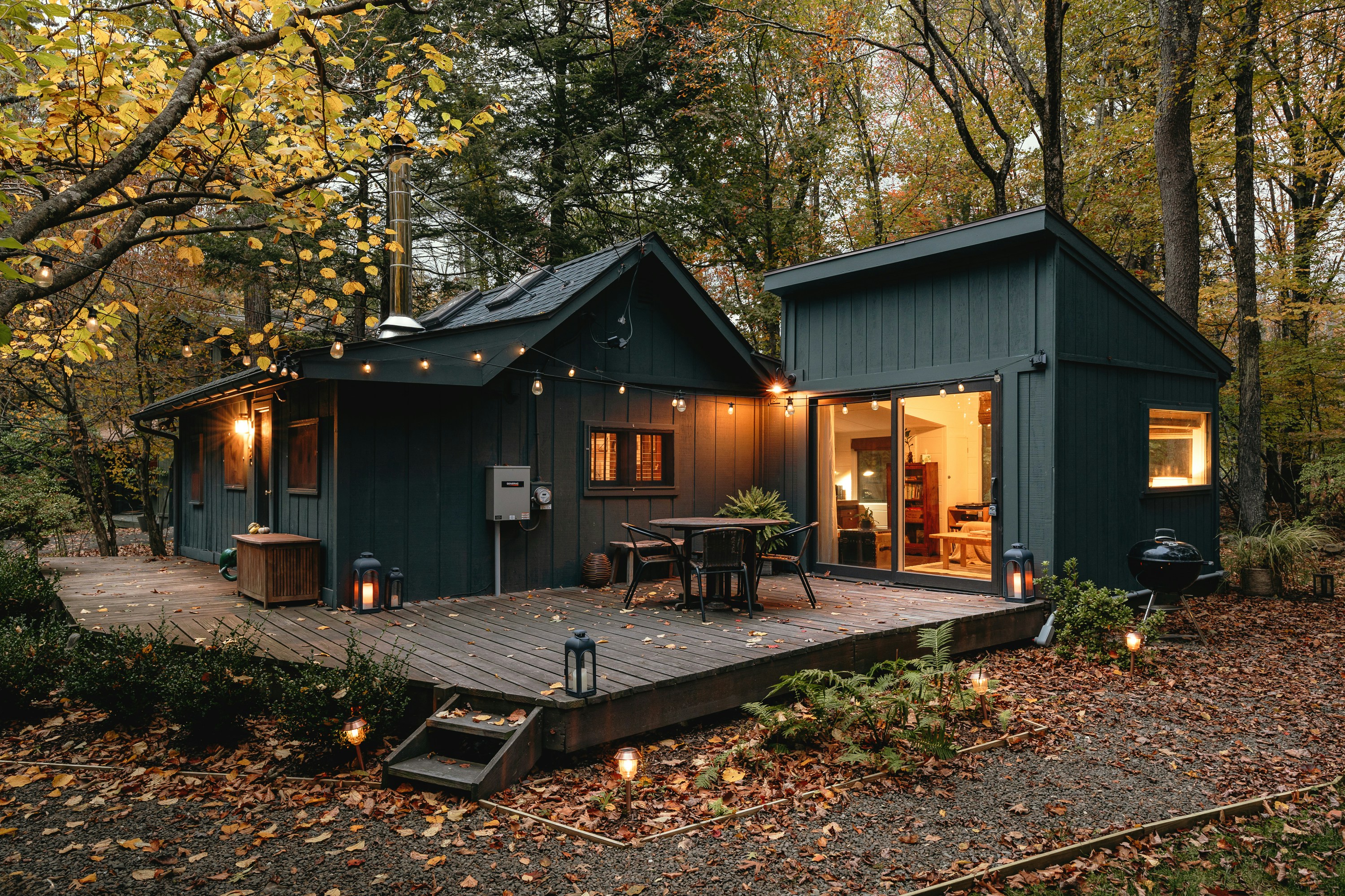 A renovated home exterior lit up at dusk